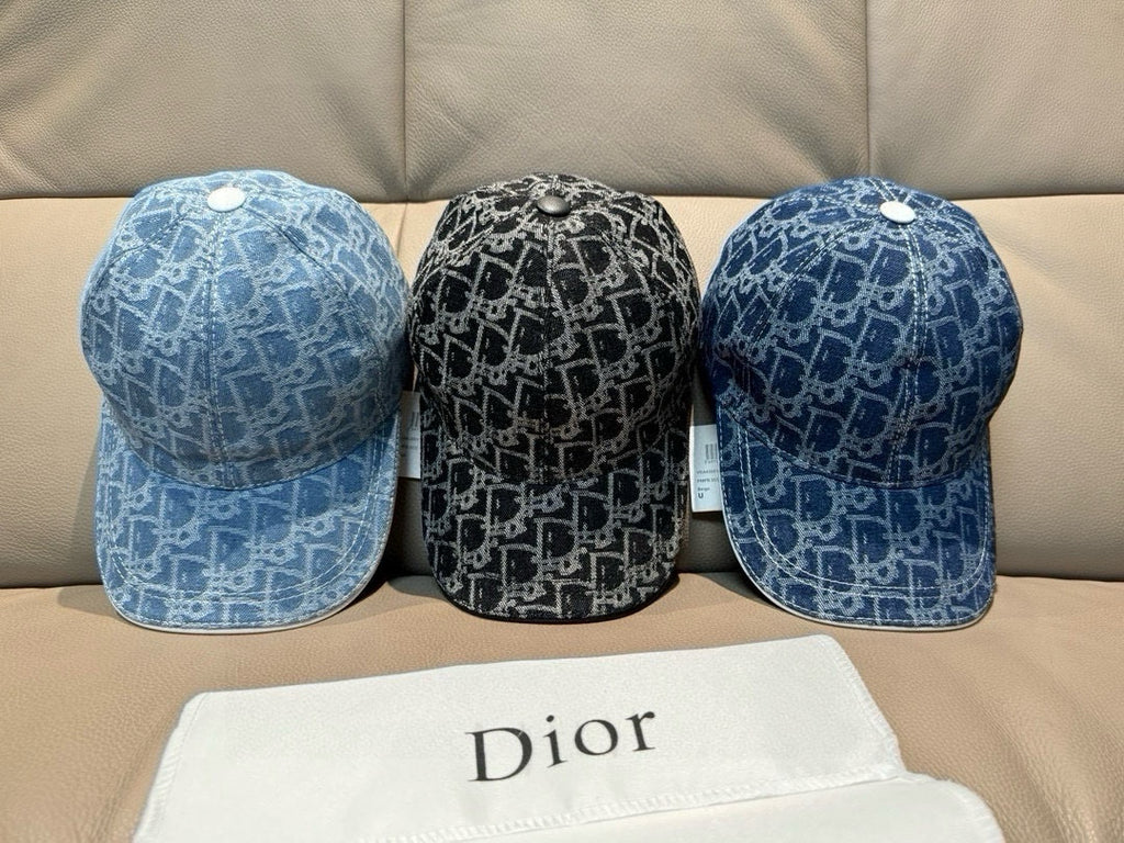 Set of three Dior caps: blue and black monogram denim caps on couch