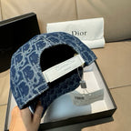 Dior logo-print denim cap in dark blue with open interior and adjustable strap.
