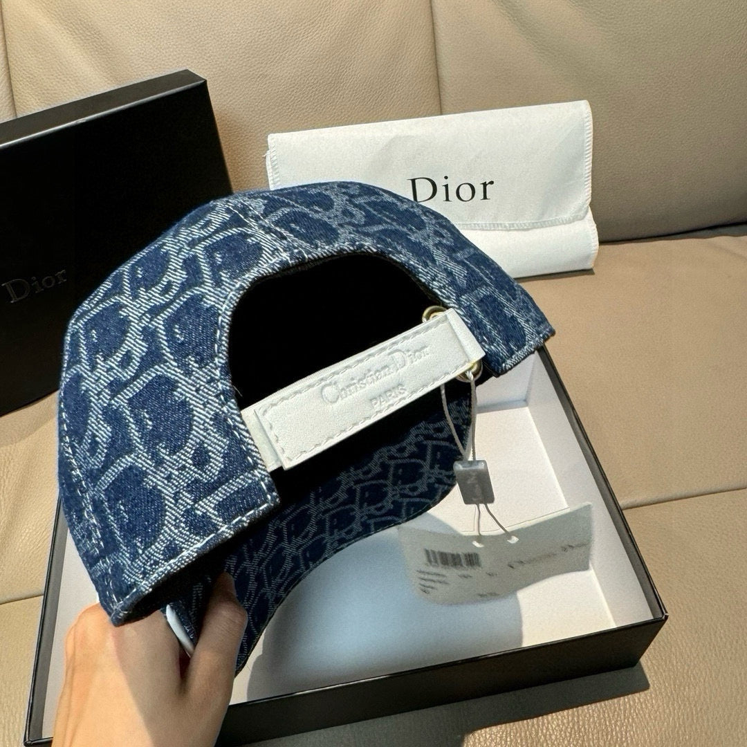 Dior logo-print denim cap in dark blue with open interior and adjustable strap.