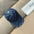 Dior logo-print denim cap in dark blue with white snap button on top.