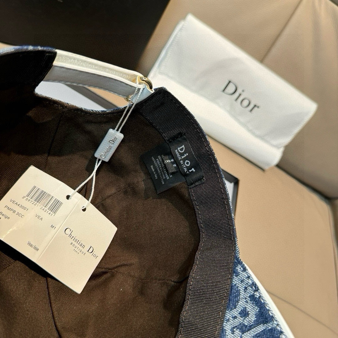 Dior denim cap in dark blue with adjustable strap and product tags visible.