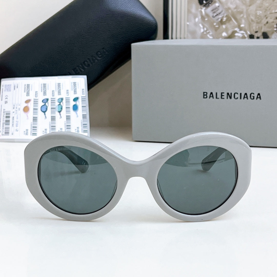 Balenciaga sunglasses with white oversized rounded frames and gray-tinted lenses