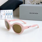 Balenciaga sunglasses with pink round frames and brown-tinted lenses