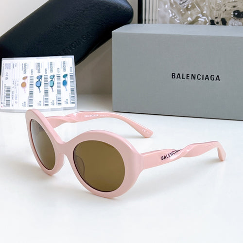 Balenciaga sunglasses with pink round frames and brown-tinted lenses