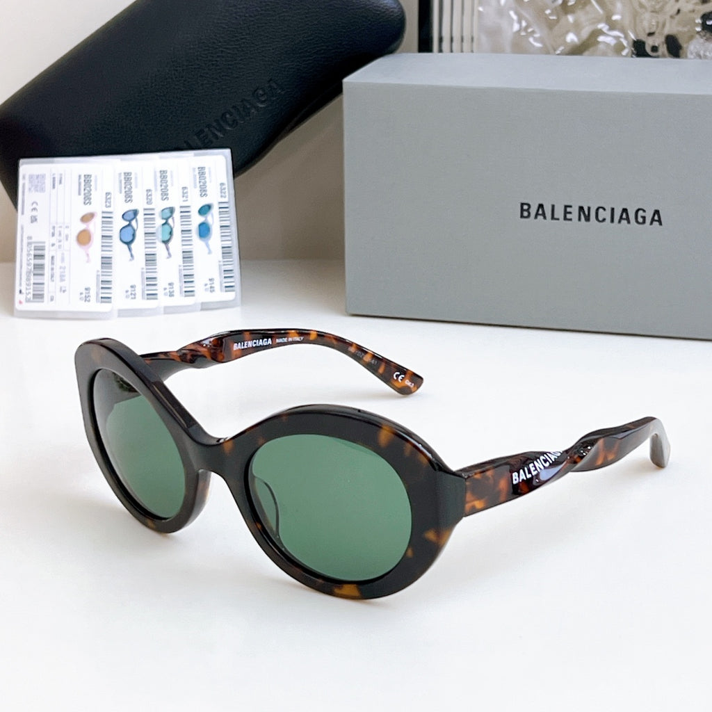 Balenciaga sunglasses with tortoiseshell frames and green-tinted lenses