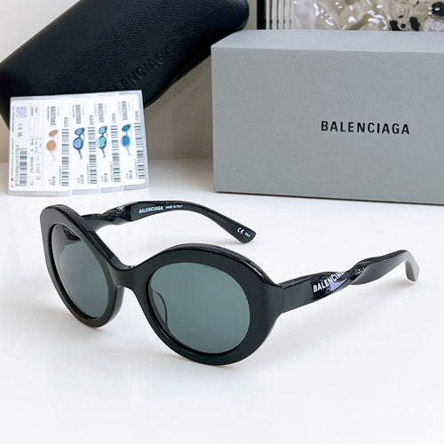 Balenciaga sunglasses with black round frames and gray-tinted lenses