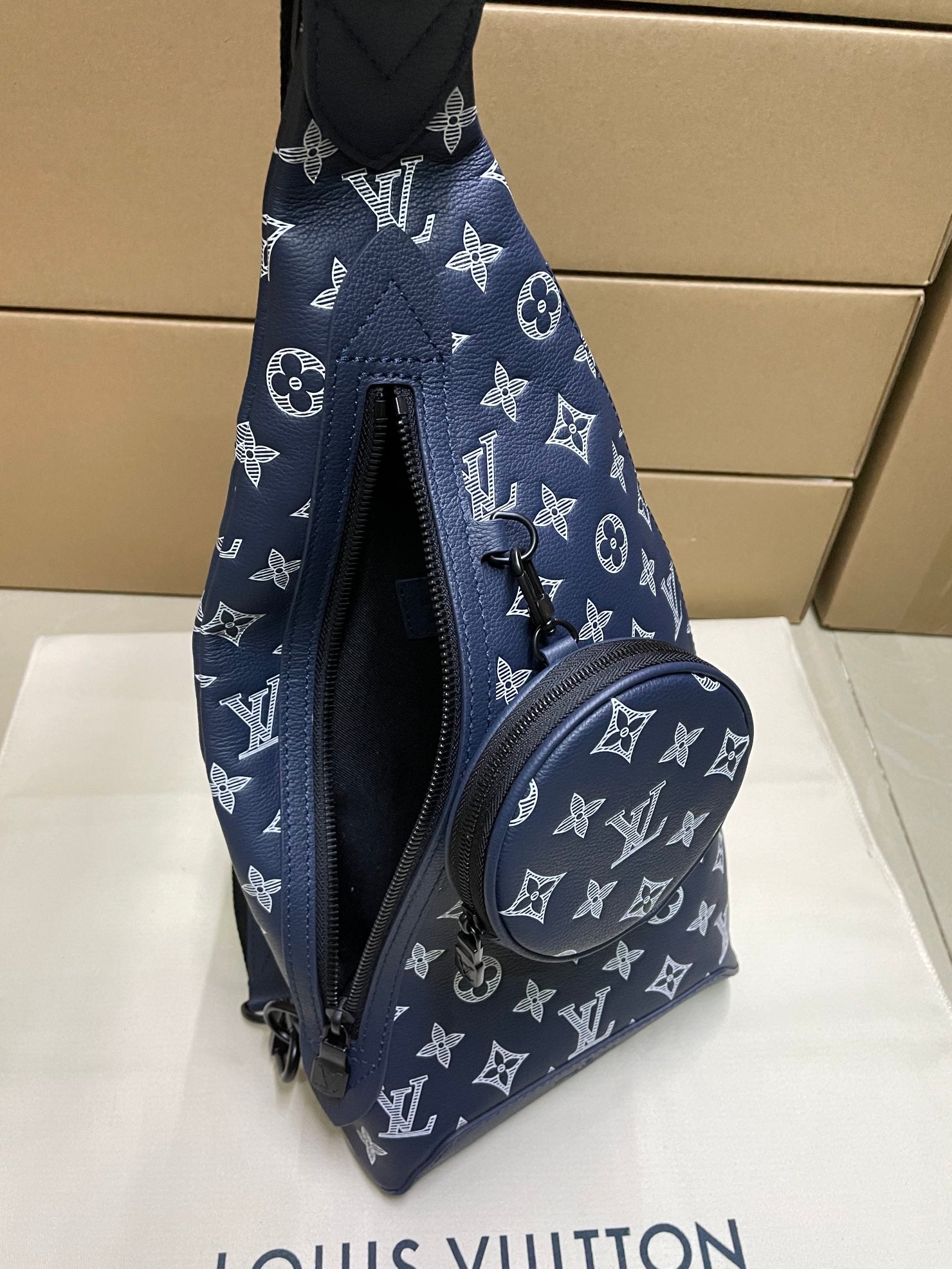 Louis Vuitton monogram bag in navy with zip front and curved crossbody strap