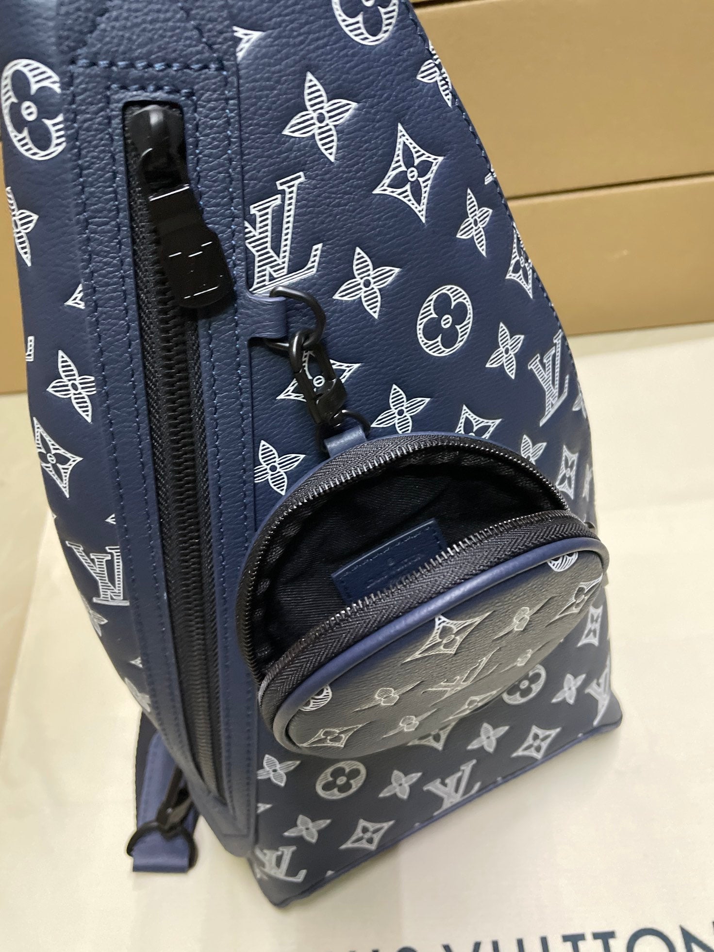 Louis Vuitton monogram bag front detail in navy with zip closure and logo pattern