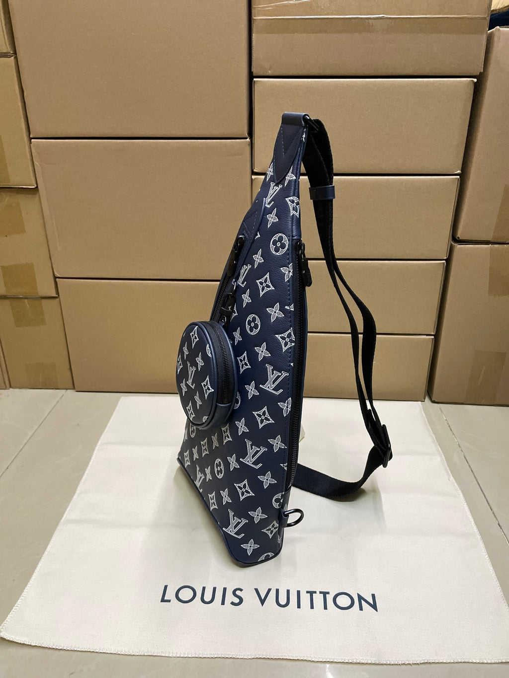 Men's navy monogram tote-style bag with long shoulder strap and two zips