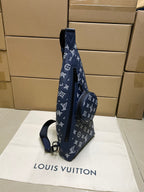 Men's navy monogram crossbody bag with circular side handle, zip closure