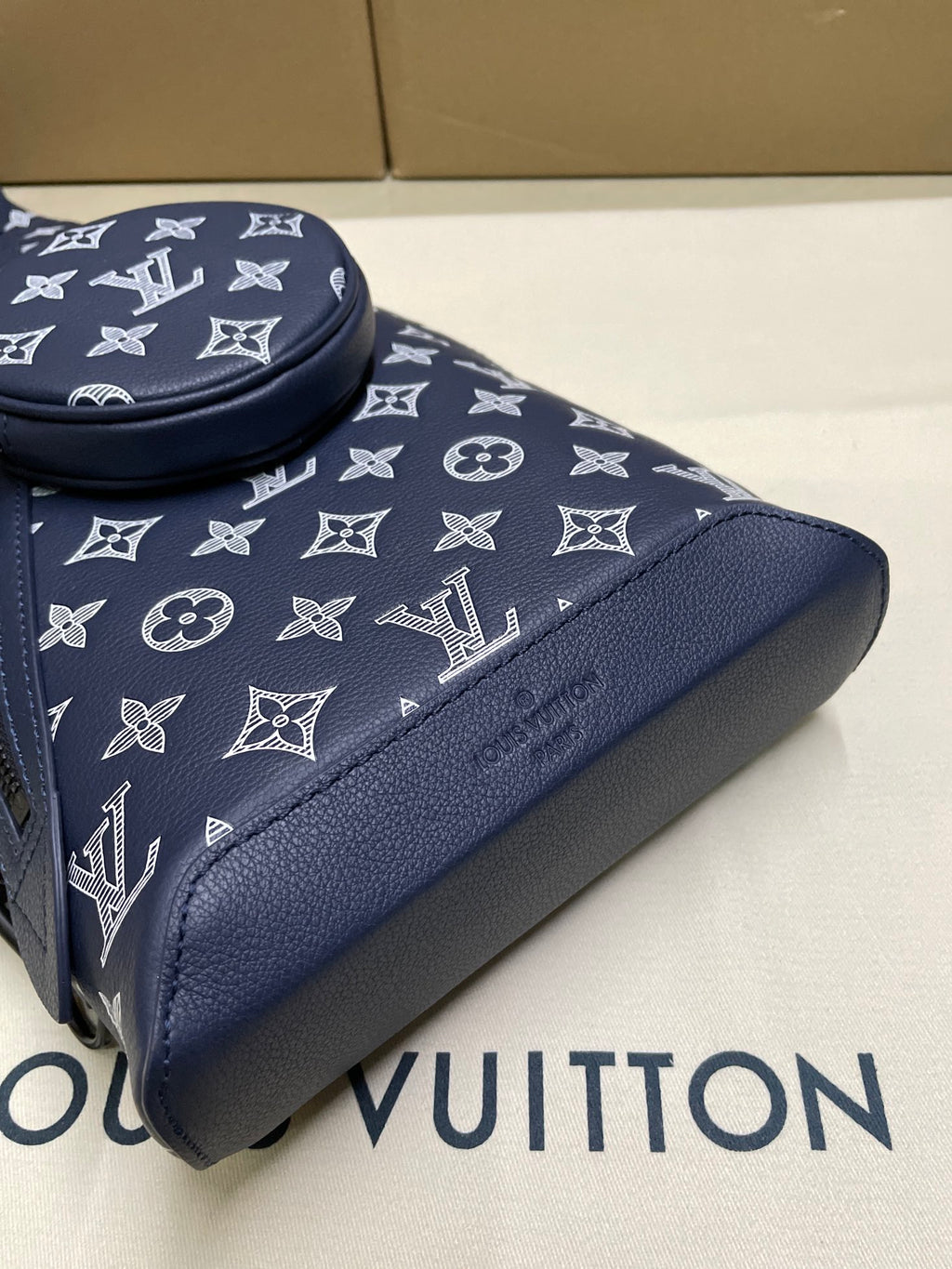 Men's navy monogram bag corner with textured trim and zip edge