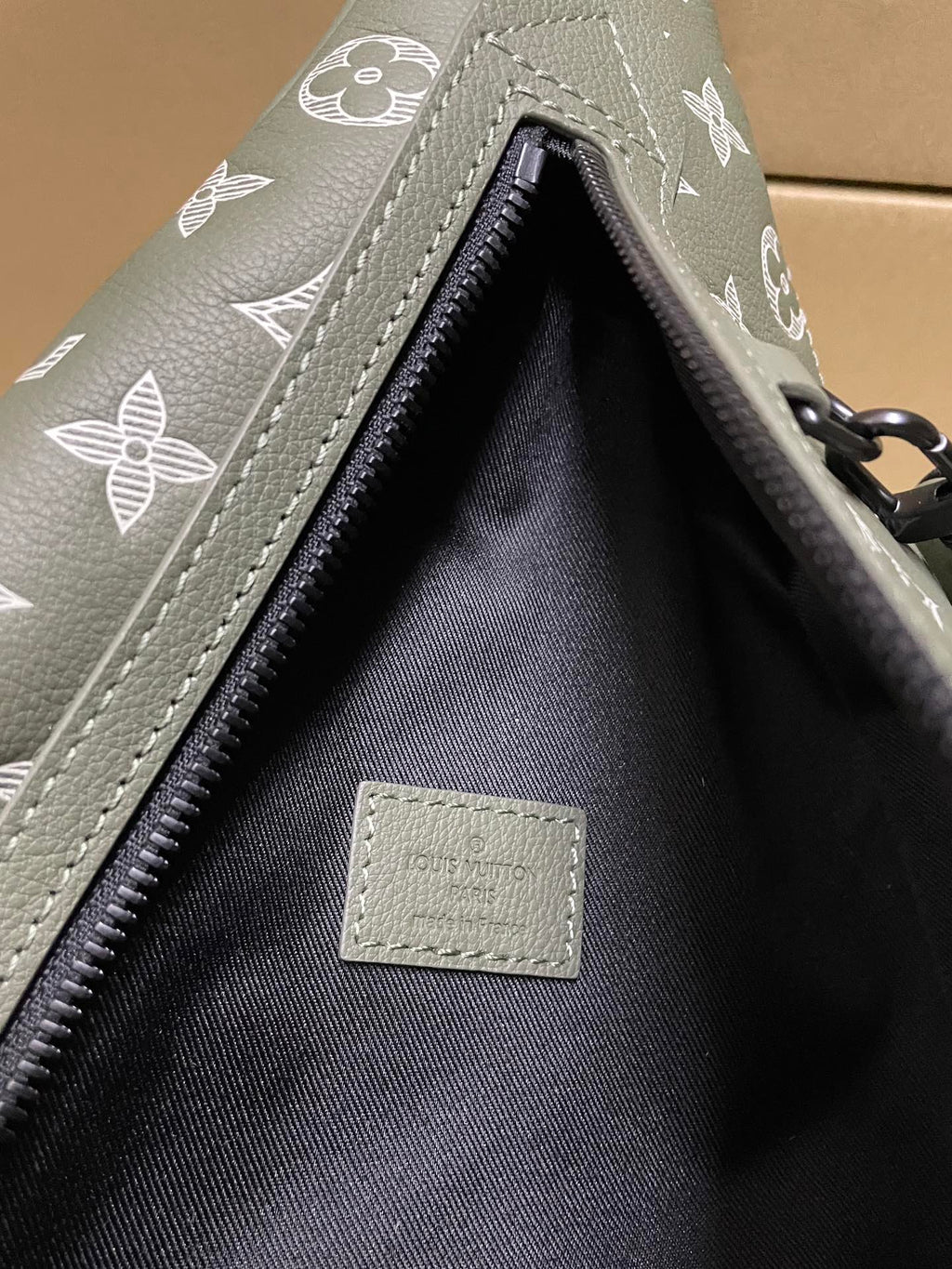 Louis Vuitton monogram sling bag interior, open zipper and fabric lining label