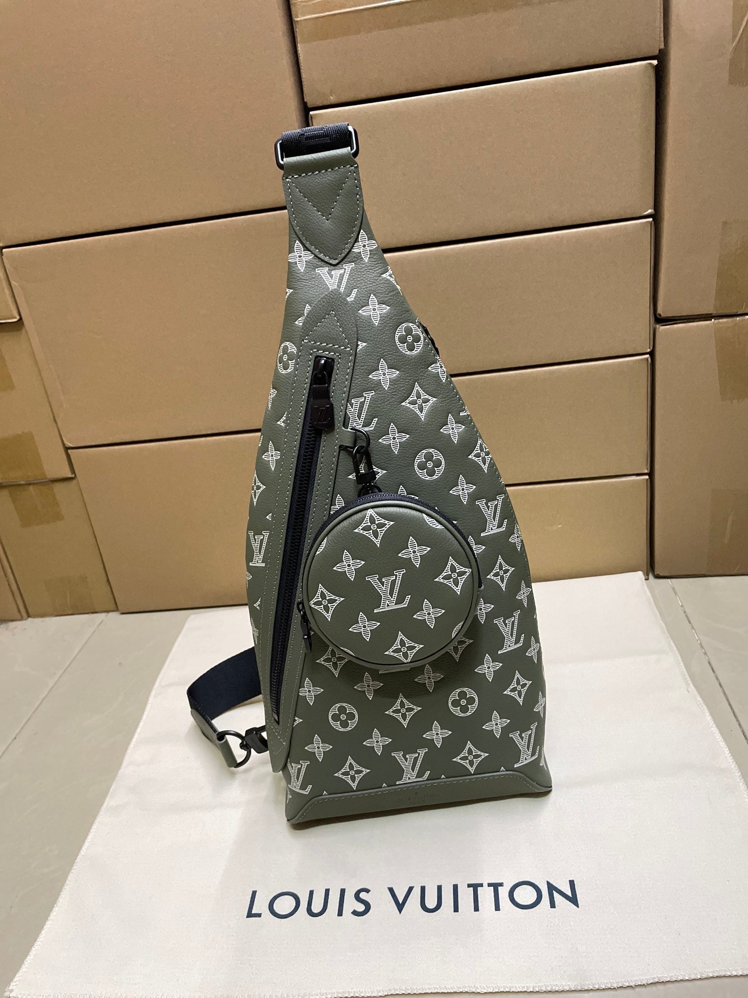 Louis Vuitton monogram mini sling bag in olive green, front view with strap