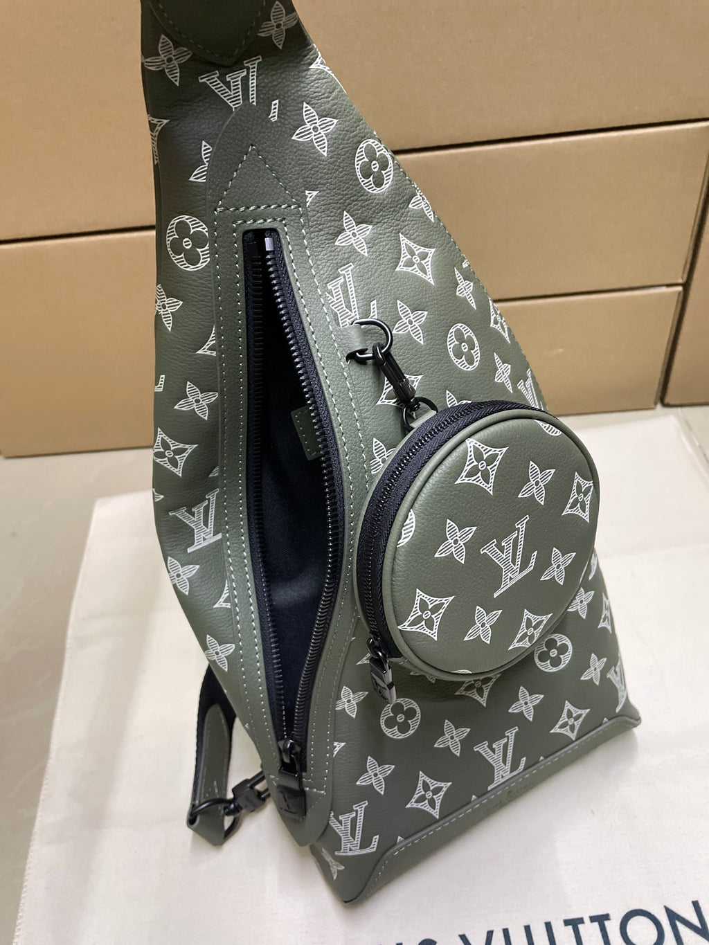 Louis Vuitton monogram sling bag in olive green, round front pouch and zipper