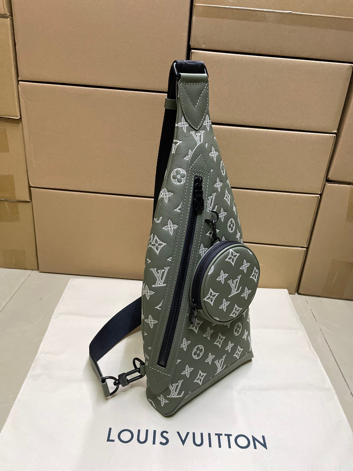Louis Vuitton men's sling bag, dark olive monogram with front zipper and circular pocket