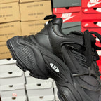 Black Balenciaga unisex sneaker side view with thick rubber sole tread and logo detail