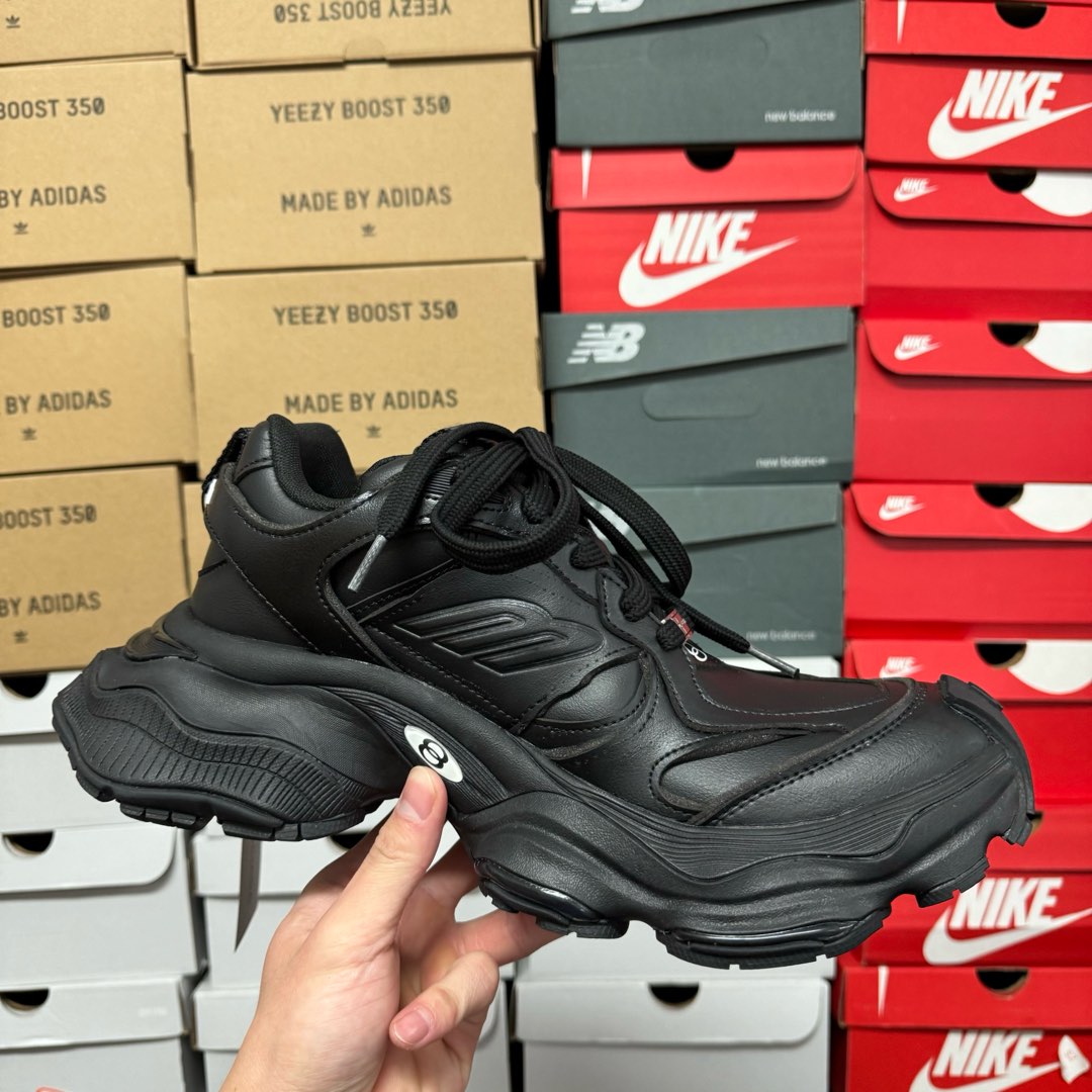 Black Balenciaga unisex chunky sneakers, three-quarter side view with lace-up design