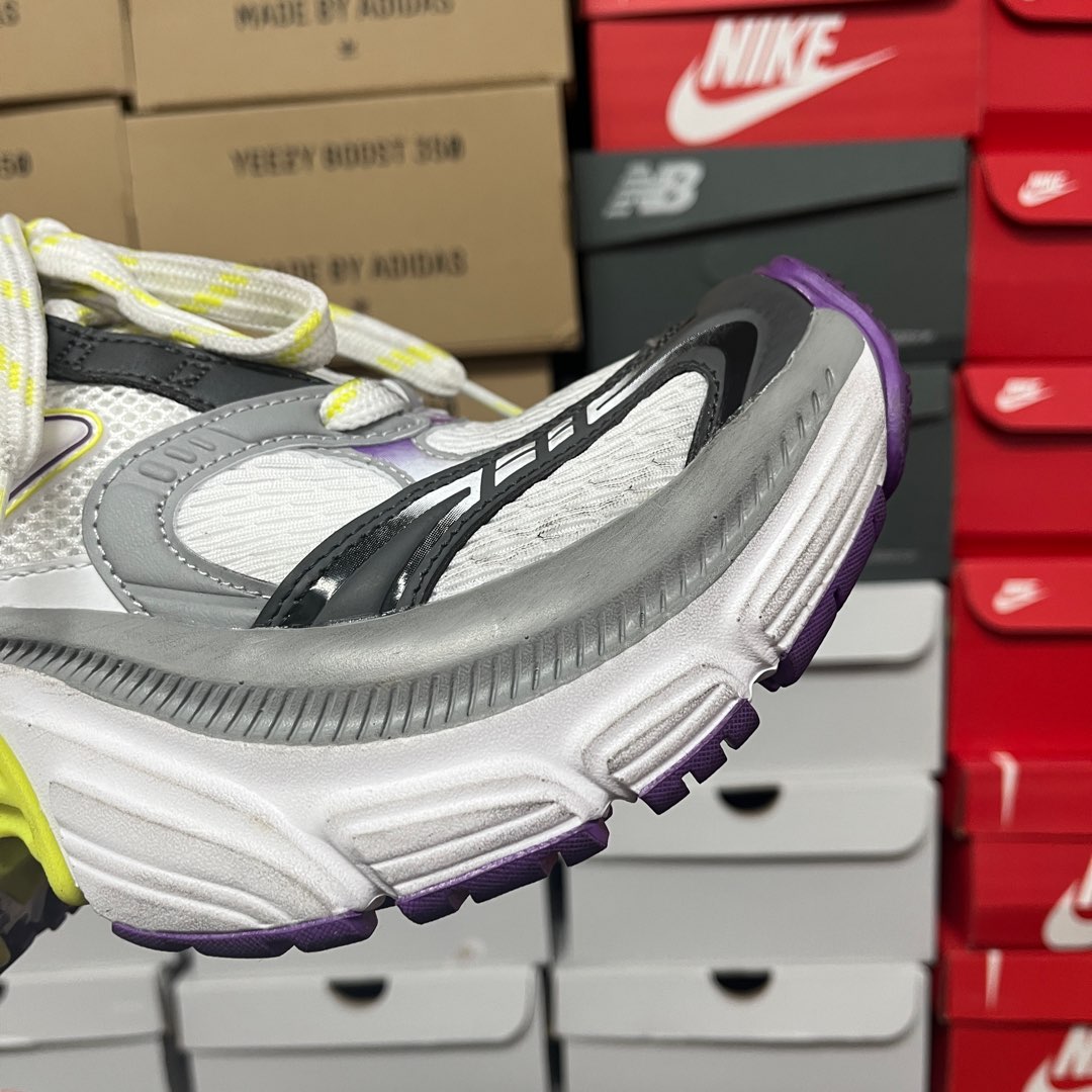 White and gray sneaker sole with black logo stripe, purple trim and lime accent.