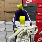 White sneaker tongue with neon green strap and Balenciaga text.