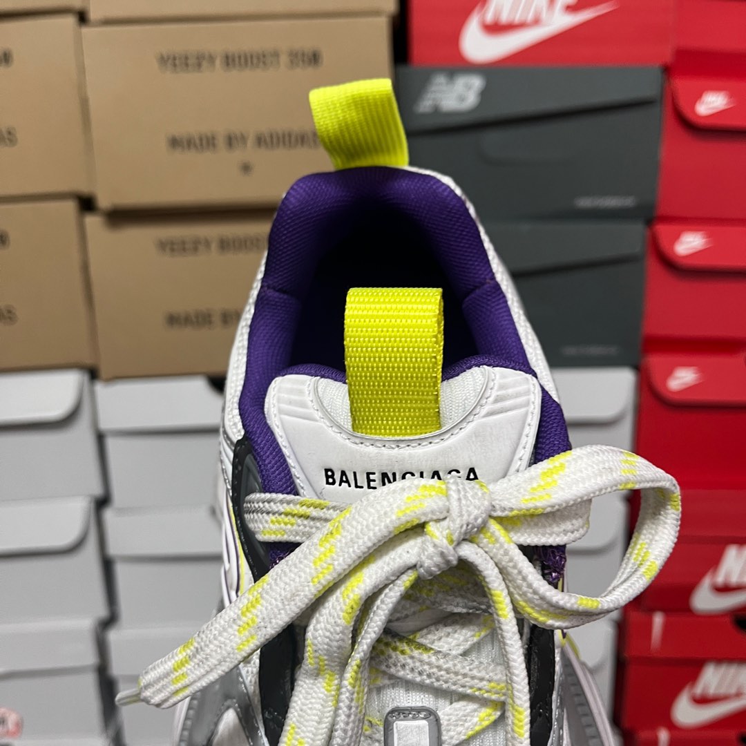 White sneaker tongue with neon green strap and Balenciaga text.