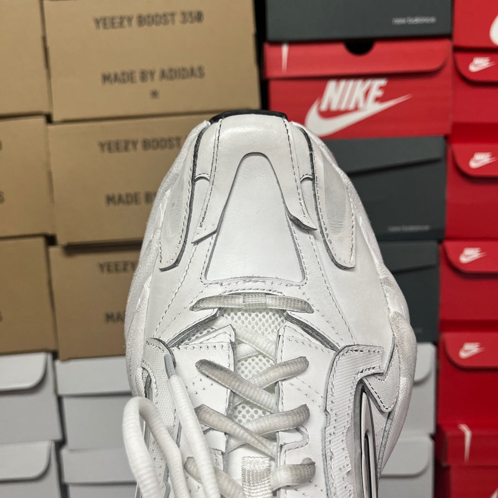 White lace-up athletic sneaker with perforated toe and textured tongue lining