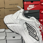 White lace-up athletic sneaker angled view with side logo panel