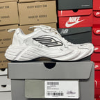 White lace-up athletic sneaker with side logo panel and ribbed midsole