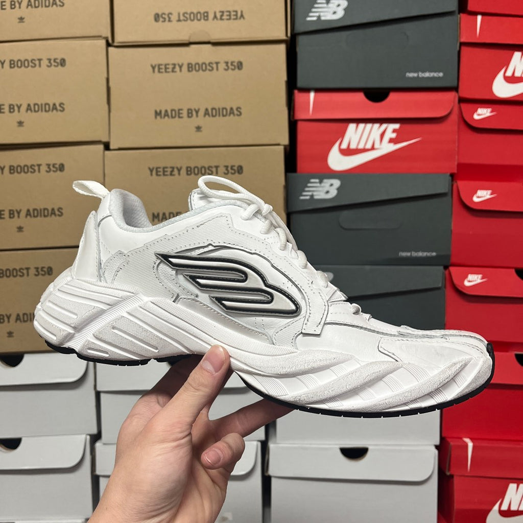 White lace-up athletic sneaker side view with black logo stripes