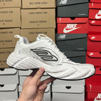 White lace-up athletic sneaker side view with black logo stripes
