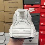 White athletic sneaker heel with rear pull tab and stacked cushioning sole