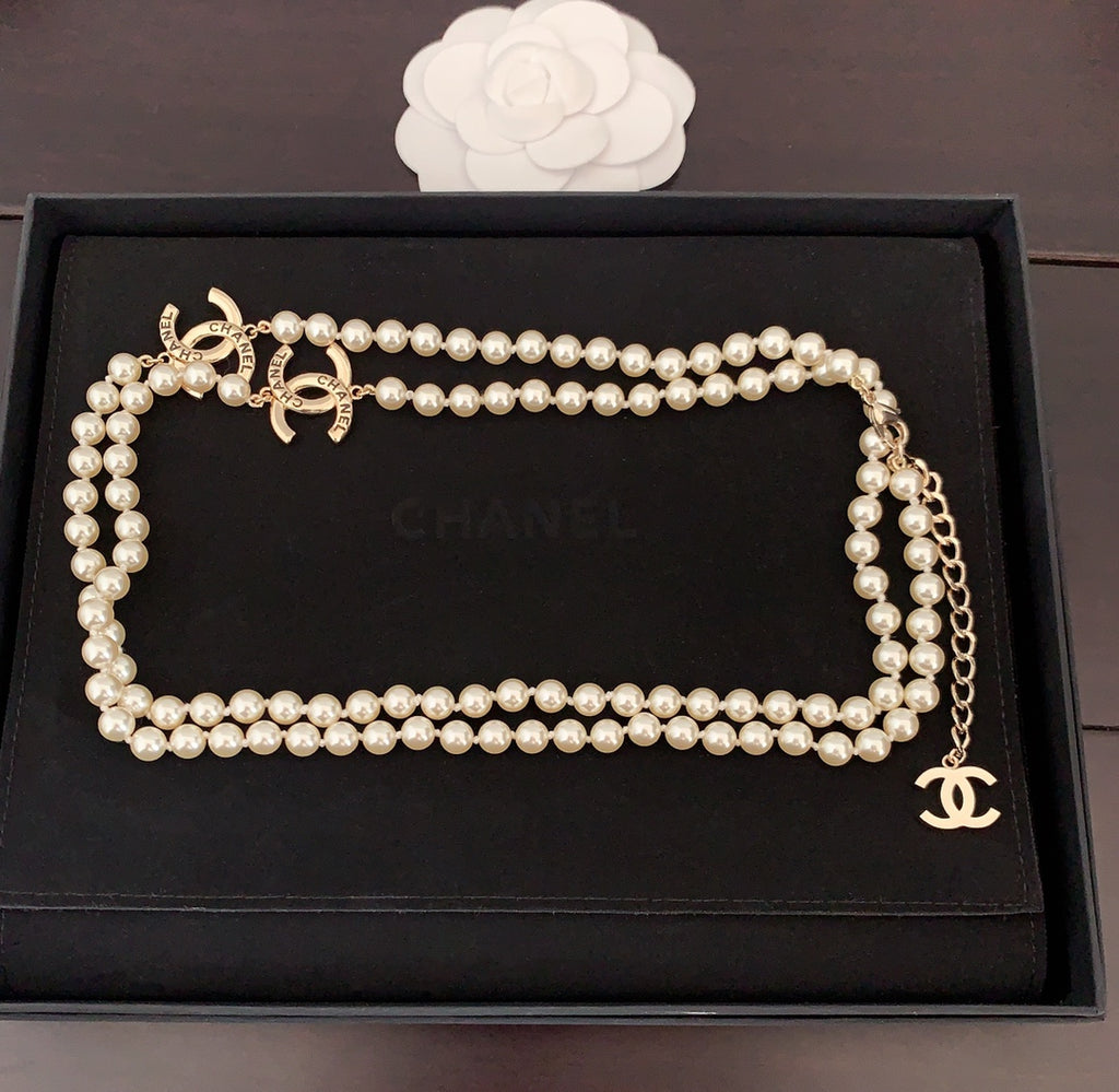 Pearl necklace displayed in a box with interlocking gold CC charm