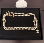 Pearl necklace displayed in a box with interlocking gold CC charm