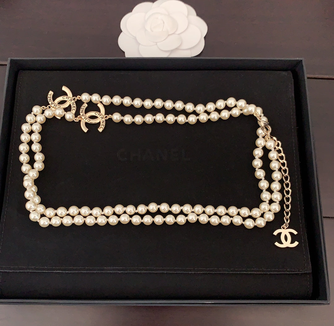 Pearl necklace displayed in a box with interlocking gold CC charm