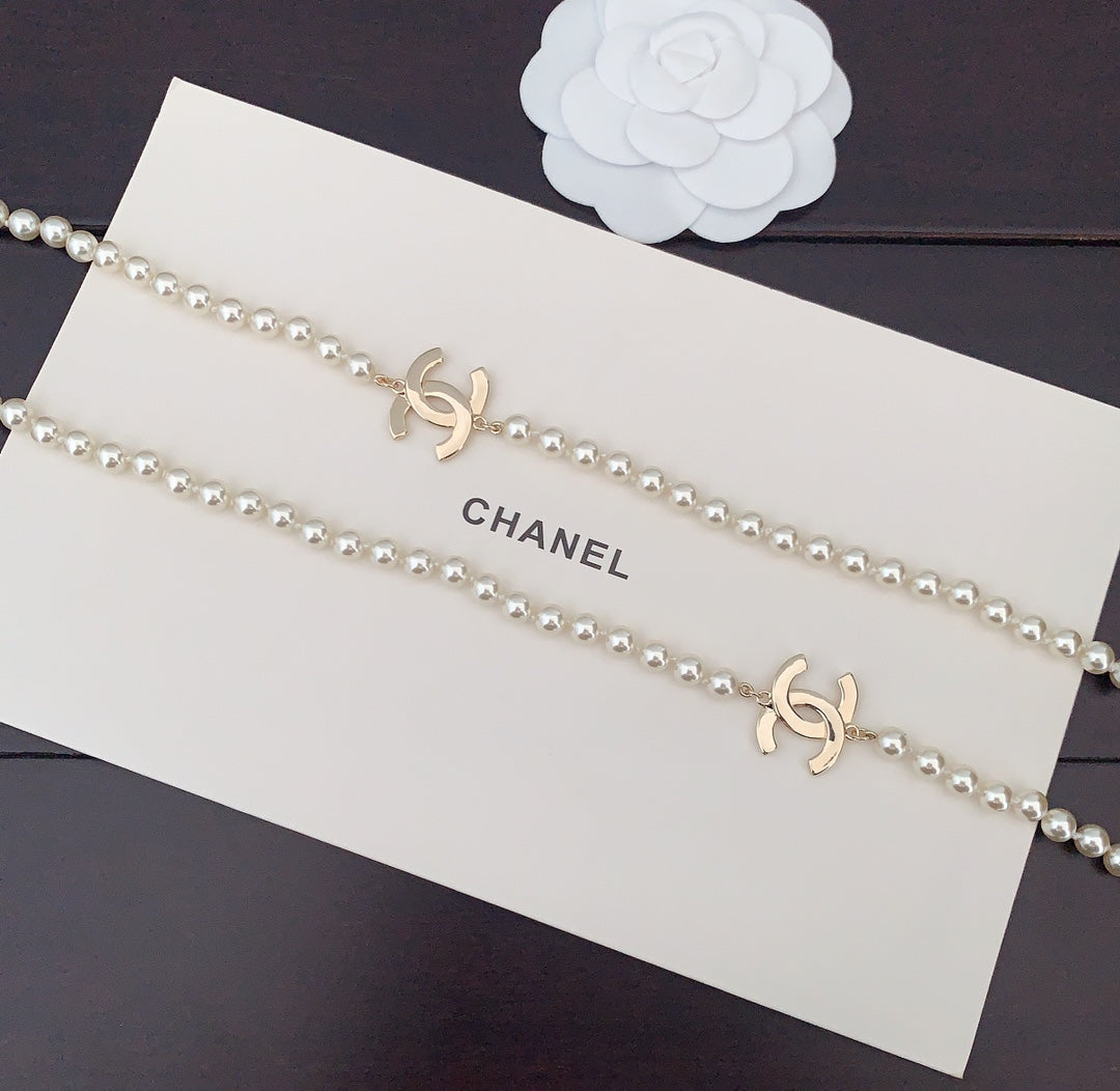 Pearl necklace with gold CC logo charms along a double strand