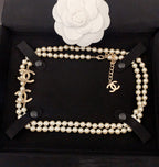 Pearl necklace with gold CC pendant and layered pearl loops