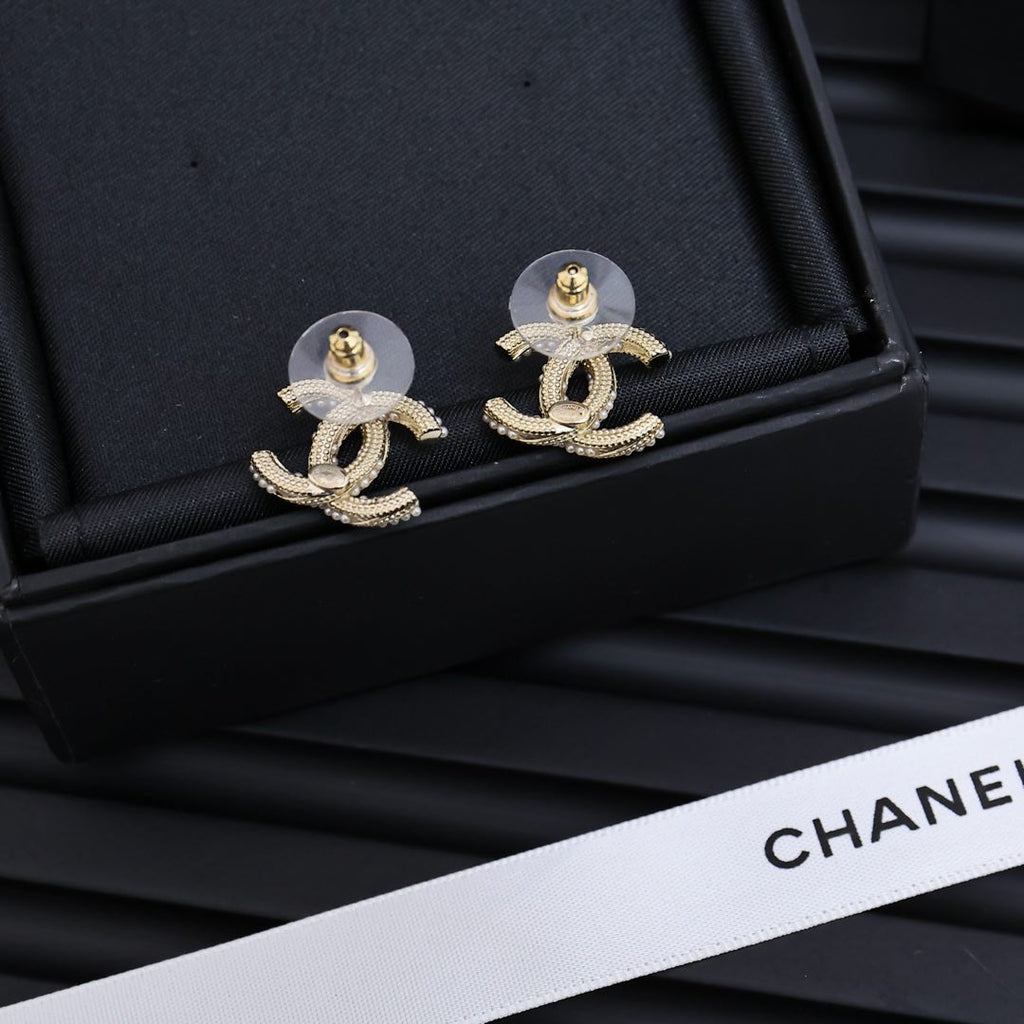 Silver-tone Chanel CC stud earrings with rhinestone detailing and gold-tone button backs