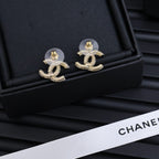 Silver-tone Chanel CC stud earrings with rhinestone detailing and gold-tone button backs