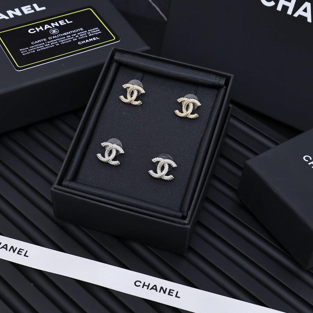 Set of four silver-tone Chanel CC stud earrings with rhinestone accents in box