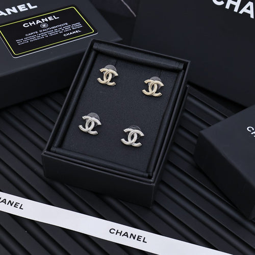 Set of four silver-tone Chanel CC stud earrings with rhinestone accents in box