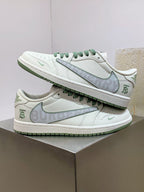 Burberry sneakers stacked on box, white leather with green lace trim and swoosh detail
