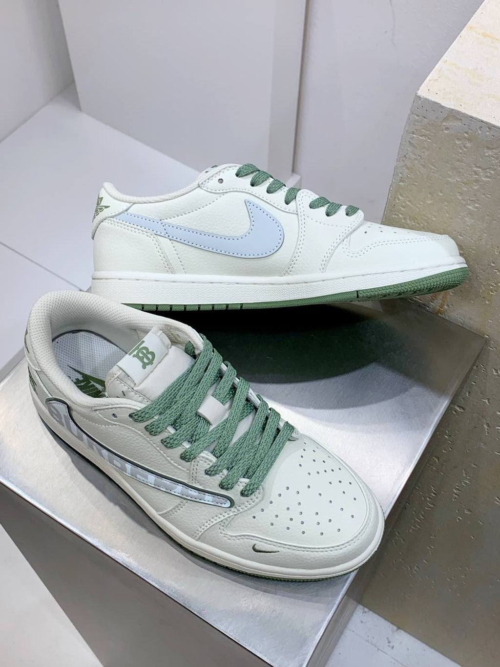 Burberry sneakers, white upper with blue logo and green laces; side angle pair