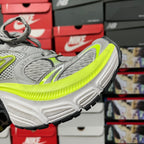 Grey running shoe side view with neon green midsole and thick tread sole