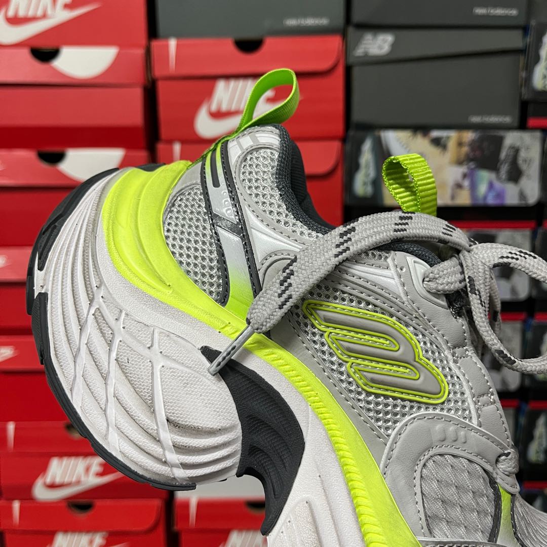 Grey and neon green running sneaker with textured panels and lace-up front