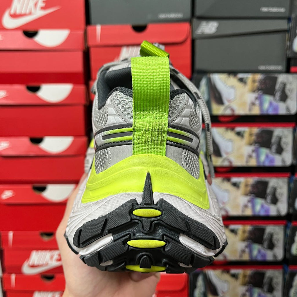 Grey sneaker heel with neon green pull tab and cushioned back sole