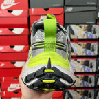 Grey sneaker heel with neon green pull tab and cushioned back sole
