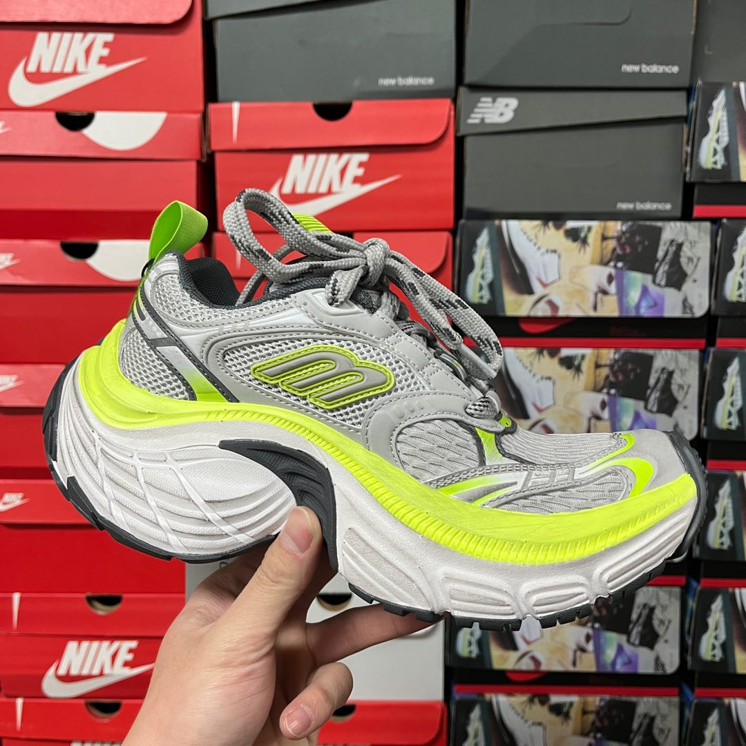 Grey lace-up running sneaker with neon green midsole stripe and curved sole