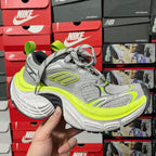 Grey running shoe with neon green accents, lace-up and chunky white sole