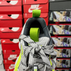 Grey lace-up sneaker with neon green heel strap and woven collar detail