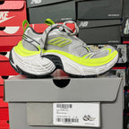 Grey lace-up running sneaker with neon green heel pull and cushioned sole