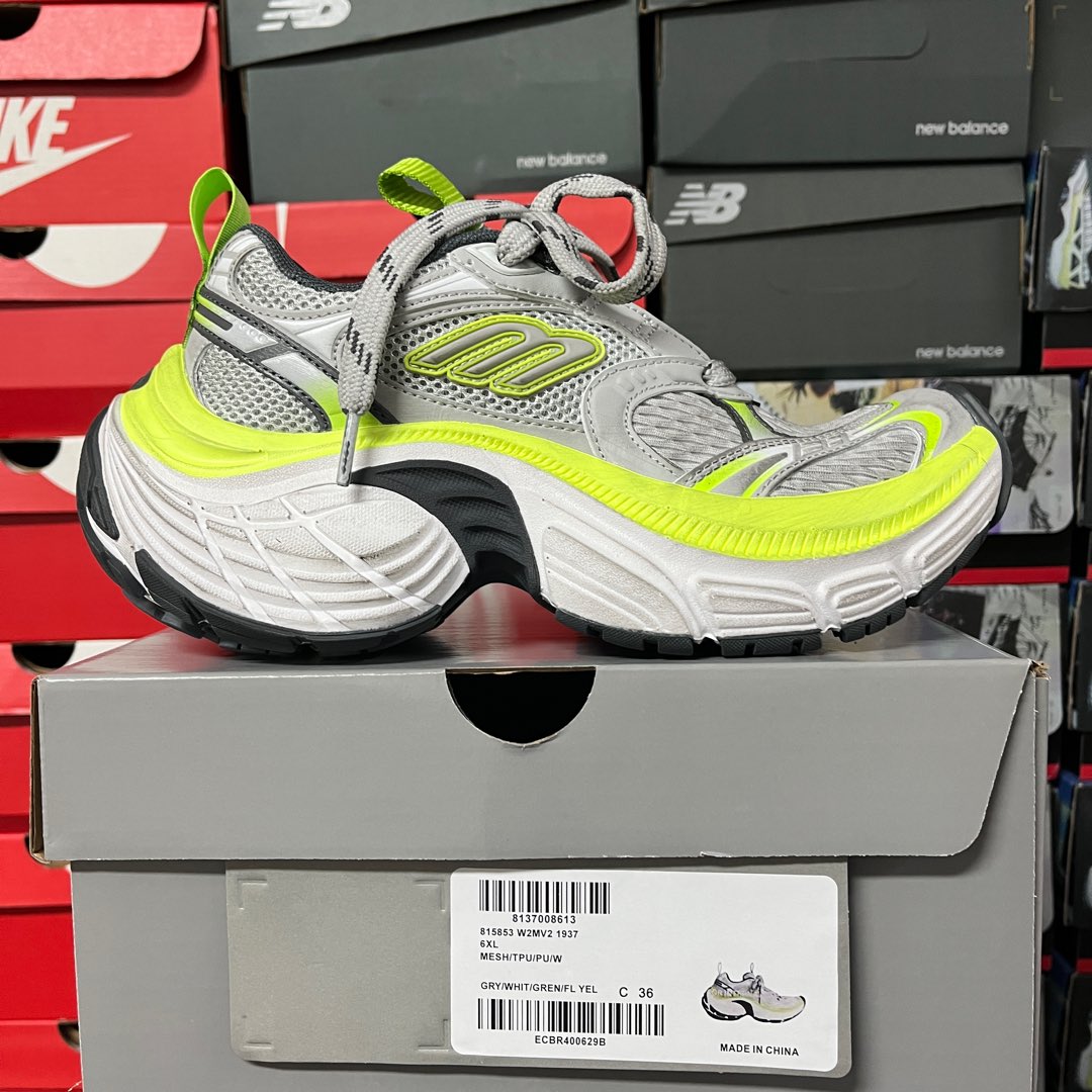 Grey lace-up running sneaker with neon green heel pull and cushioned sole